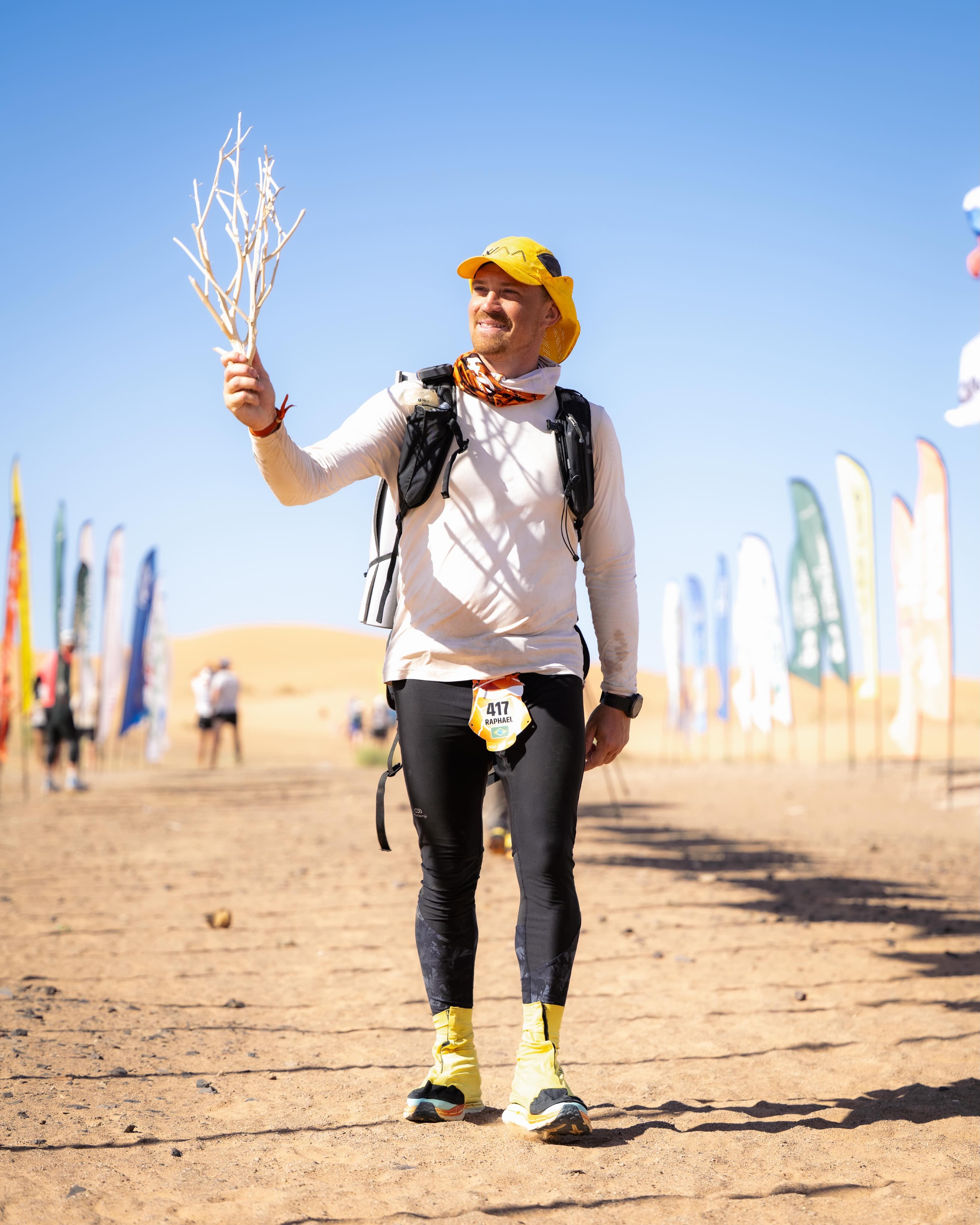 Athletes running through sand dunes