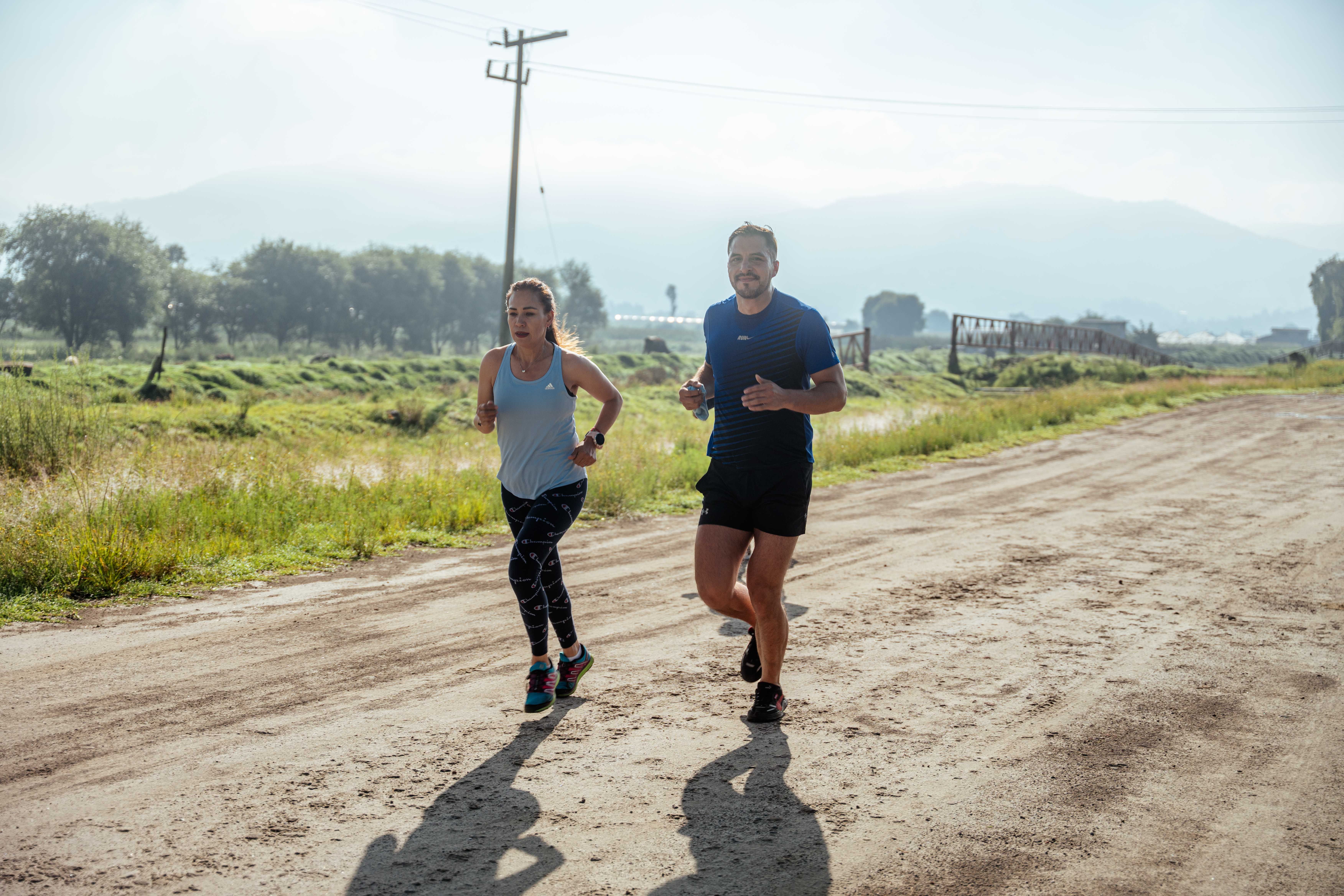 Two runners training together on a dirt track